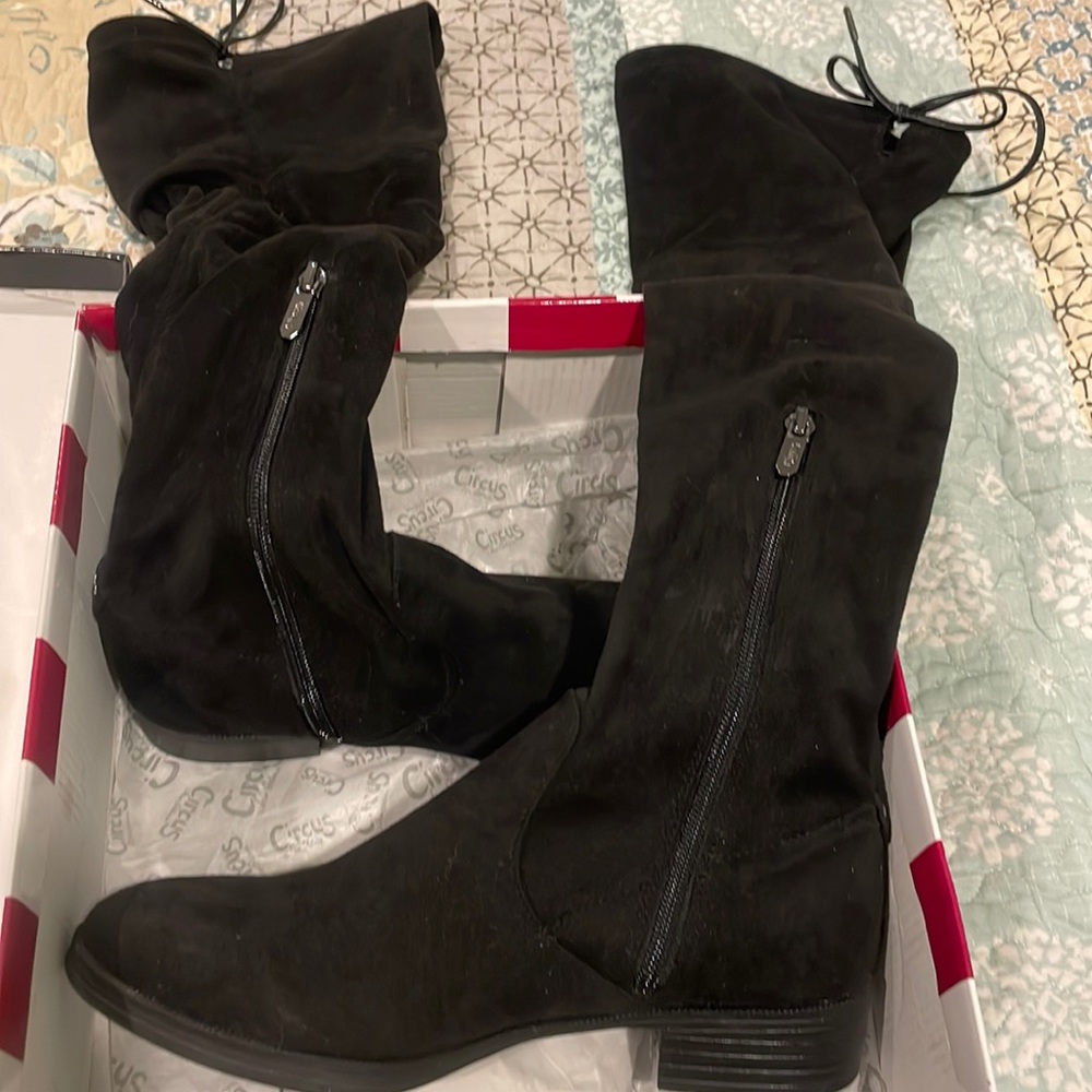 Knee high boots with ties at top. Size 8.5. Worn only once.